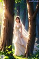 A woman in a wedding dress standing in the woods.