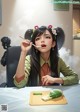 A woman sitting at a table eating a piece of food.