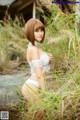 A woman in a white lingerie standing in tall grass.